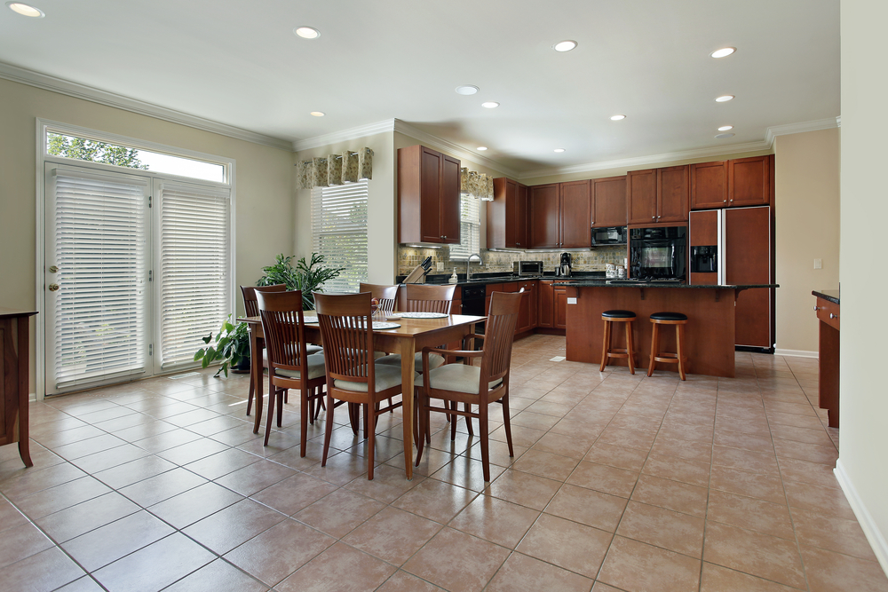 Large kitchen with redwood cabinetry and tan tiles